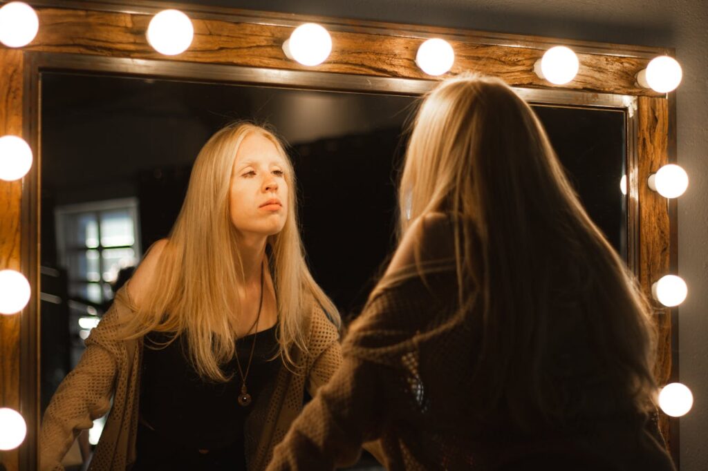 A Woman Looking at Herself in the Mirror
