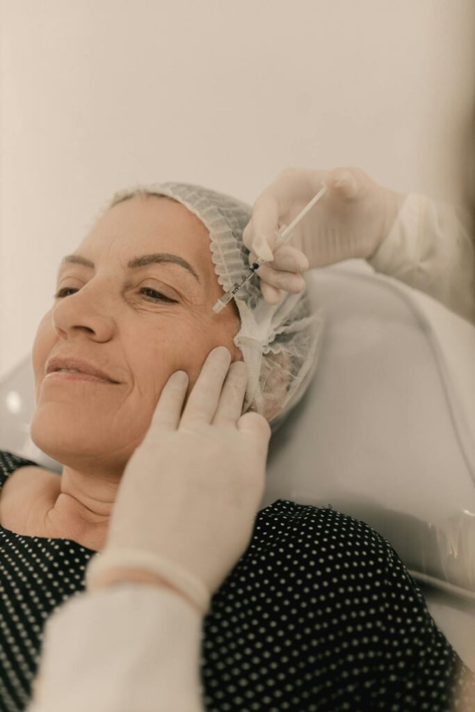 Middle-aged woman receiving cosmetic facial injection
