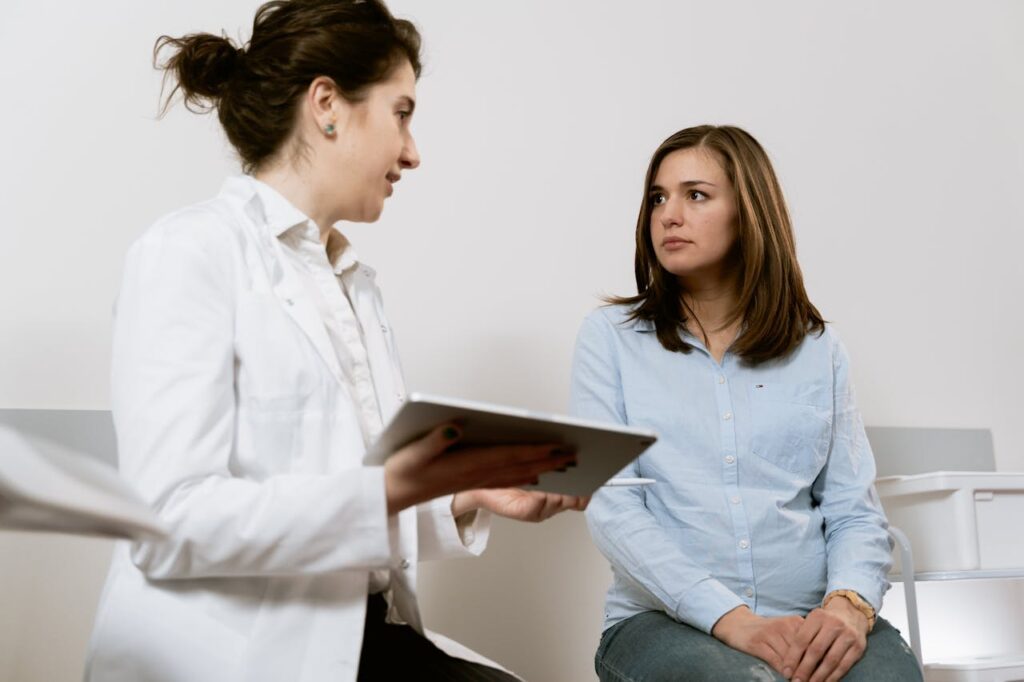 female doctor examining female patient